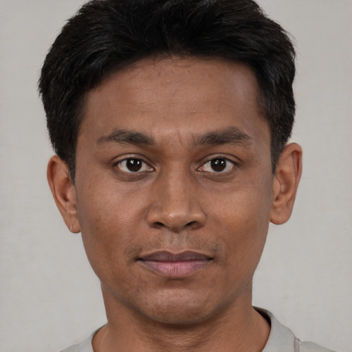 Joyful asian young-adult male with short  black hair and brown eyes