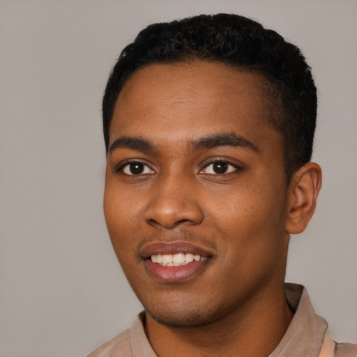 Joyful black young-adult male with short  black hair and brown eyes