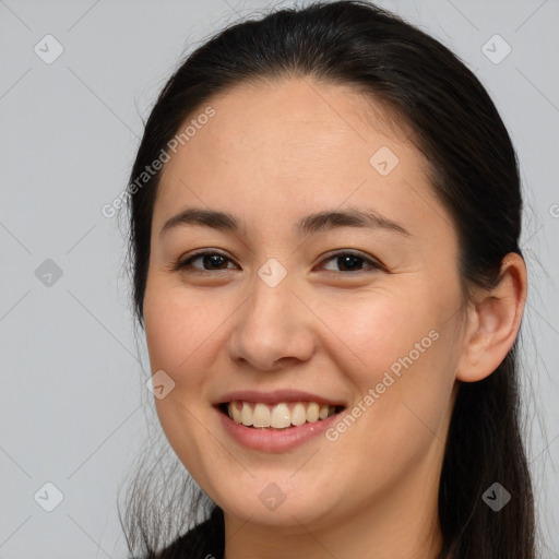 Joyful white young-adult female with long  brown hair and brown eyes