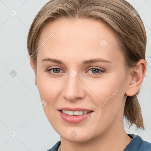 Joyful white young-adult female with medium  brown hair and blue eyes