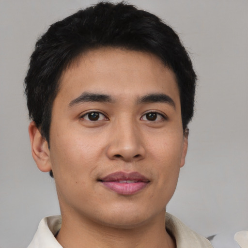 Joyful asian young-adult male with short  black hair and brown eyes