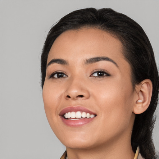 Joyful white young-adult female with long  black hair and brown eyes