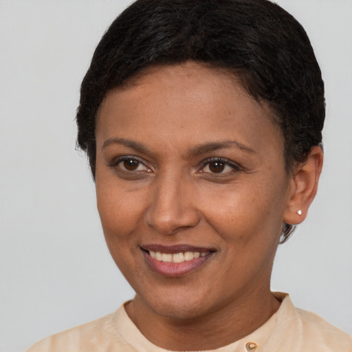 Joyful latino adult female with short  brown hair and brown eyes