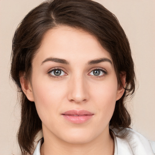 Joyful white young-adult female with medium  brown hair and green eyes