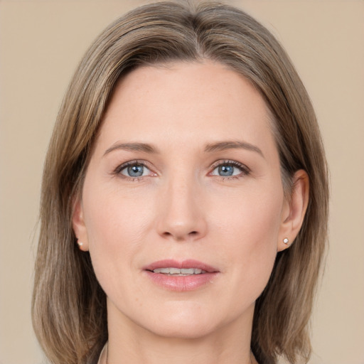 Joyful white adult female with medium  brown hair and grey eyes