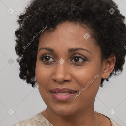 Joyful black young-adult female with short  black hair and brown eyes