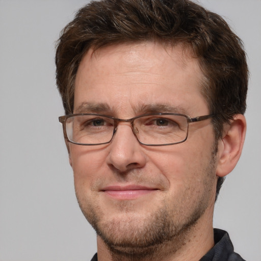 Joyful white adult male with short  brown hair and brown eyes