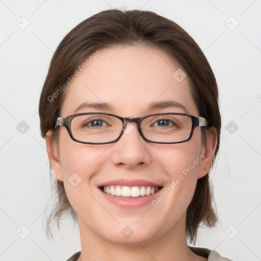 Joyful white young-adult female with medium  brown hair and grey eyes