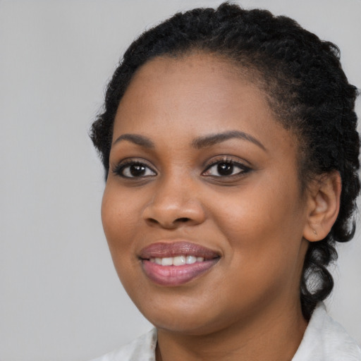Joyful black young-adult female with medium  black hair and brown eyes