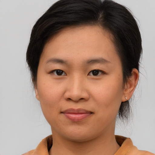 Joyful asian young-adult female with medium  brown hair and brown eyes
