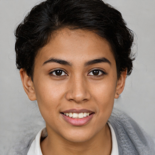 Joyful latino young-adult female with short  brown hair and brown eyes