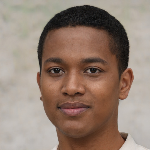Joyful black young-adult male with short  black hair and brown eyes