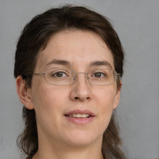 Joyful white adult female with medium  brown hair and green eyes