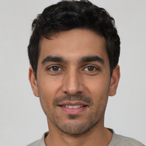 Joyful white young-adult male with short  black hair and brown eyes