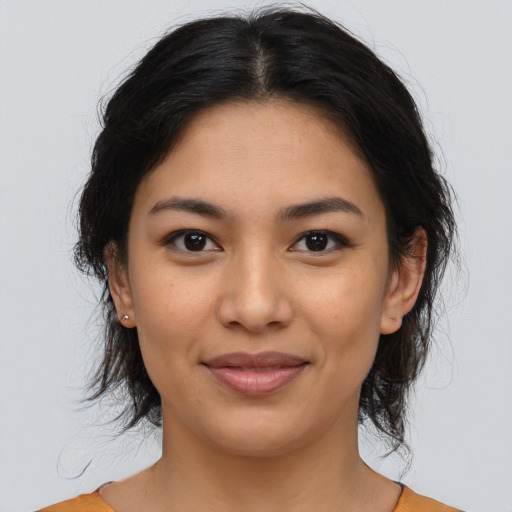 Joyful asian young-adult female with medium  brown hair and brown eyes