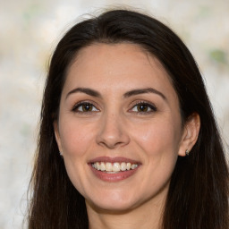 Joyful white adult female with long  brown hair and brown eyes