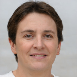 Joyful white adult female with short  brown hair and grey eyes