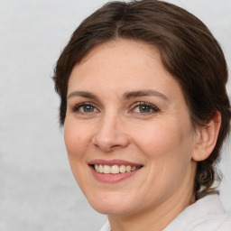 Joyful white adult female with medium  brown hair and brown eyes