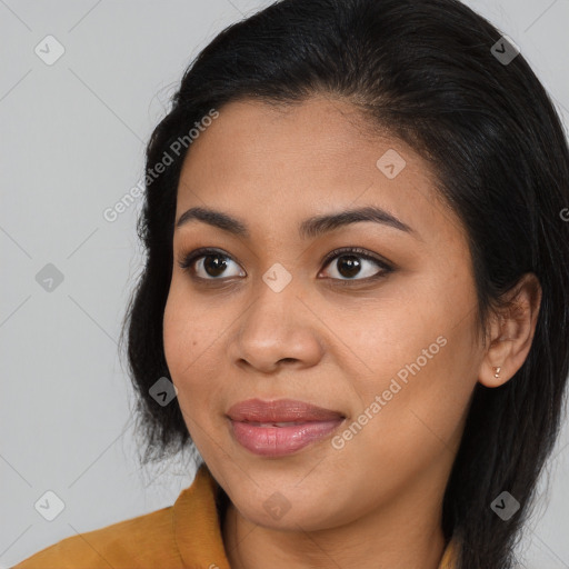 Joyful latino young-adult female with long  brown hair and brown eyes