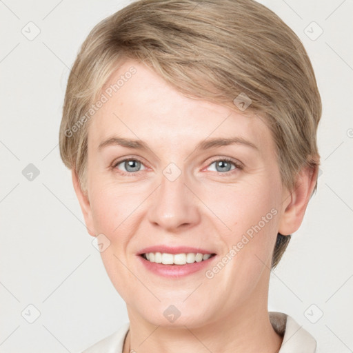 Joyful white young-adult female with short  brown hair and grey eyes