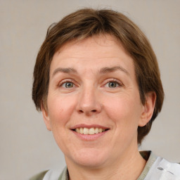 Joyful white adult female with medium  brown hair and green eyes