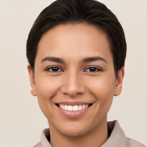 Joyful white young-adult female with short  brown hair and brown eyes