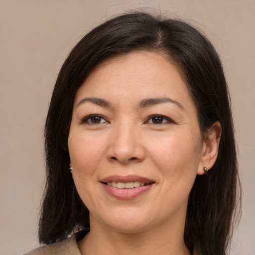 Joyful asian adult female with medium  brown hair and brown eyes