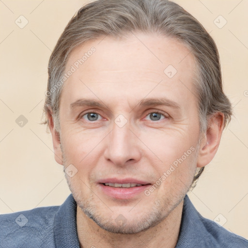 Joyful white adult male with short  brown hair and grey eyes