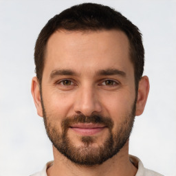 Joyful white young-adult male with short  brown hair and brown eyes