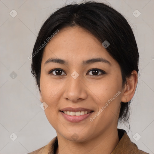 Joyful latino young-adult female with medium  brown hair and brown eyes