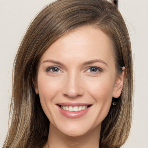 Joyful white young-adult female with long  brown hair and grey eyes