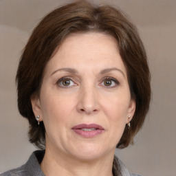 Joyful white adult female with medium  brown hair and grey eyes