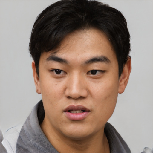 Neutral asian young-adult male with short  black hair and brown eyes