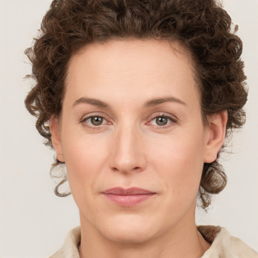 Joyful white young-adult female with medium  brown hair and green eyes