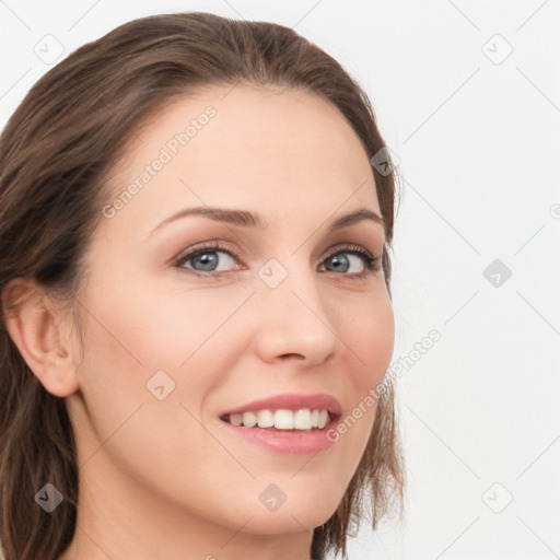 Joyful white young-adult female with long  brown hair and blue eyes