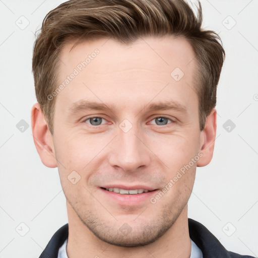 Joyful white young-adult male with short  brown hair and grey eyes