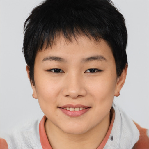 Joyful asian child female with short  brown hair and brown eyes
