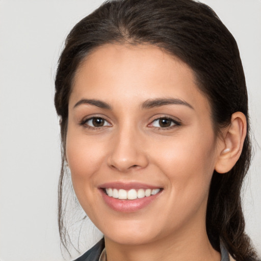 Joyful white young-adult female with long  brown hair and brown eyes