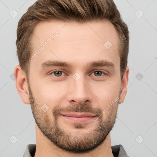 Joyful white young-adult male with short  brown hair and grey eyes