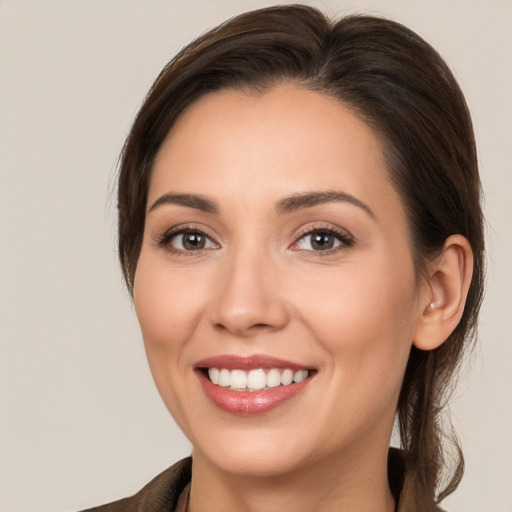 Joyful white young-adult female with medium  brown hair and brown eyes