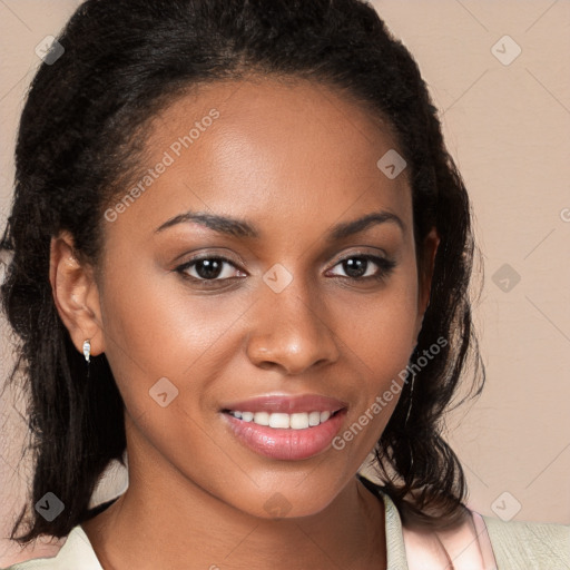 Joyful black young-adult female with long  brown hair and brown eyes