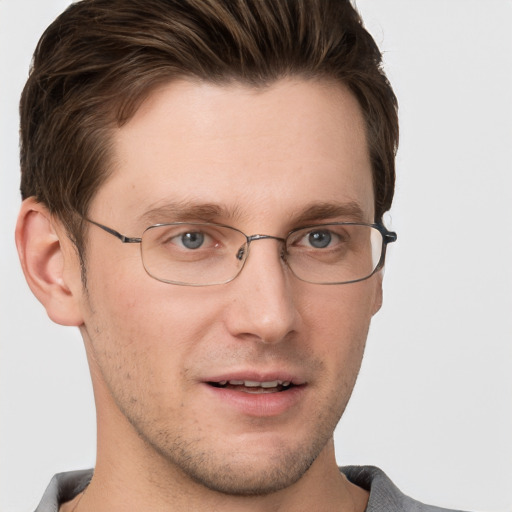 Joyful white adult male with short  brown hair and grey eyes