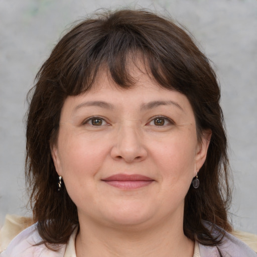 Joyful white adult female with medium  brown hair and brown eyes