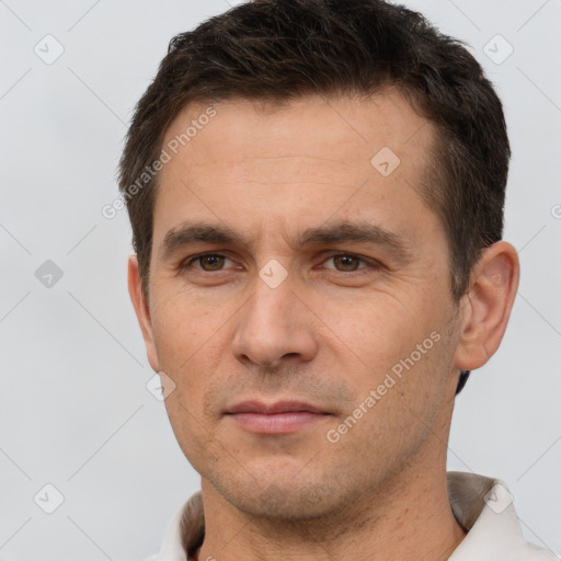 Joyful white adult male with short  brown hair and brown eyes