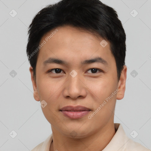 Joyful asian young-adult male with short  black hair and brown eyes