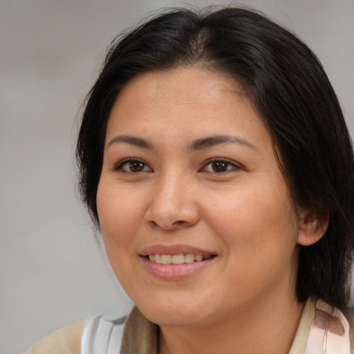 Joyful asian young-adult female with medium  brown hair and brown eyes