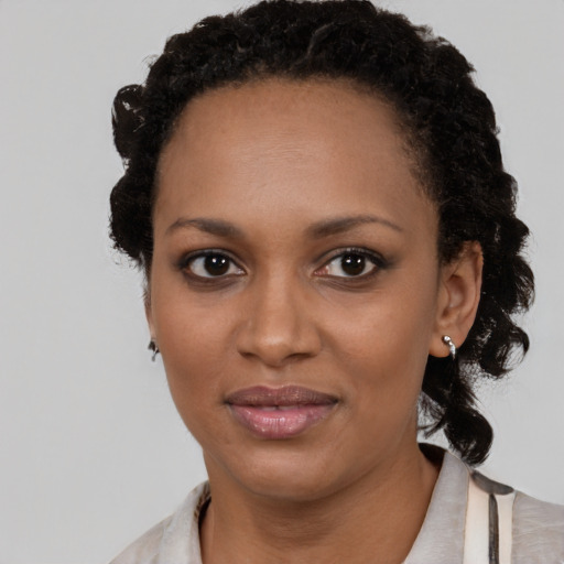 Joyful black adult female with medium  black hair and brown eyes