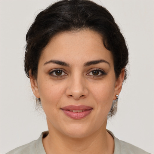 Joyful latino young-adult female with medium  brown hair and brown eyes