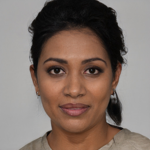 Joyful black young-adult female with medium  black hair and brown eyes