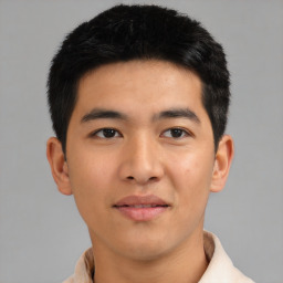 Joyful asian young-adult male with short  black hair and brown eyes